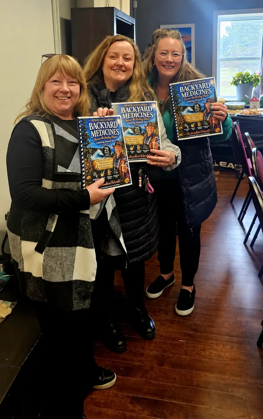 Three readers holding copies of Byron Alexander’s Backyard Medicines field guide